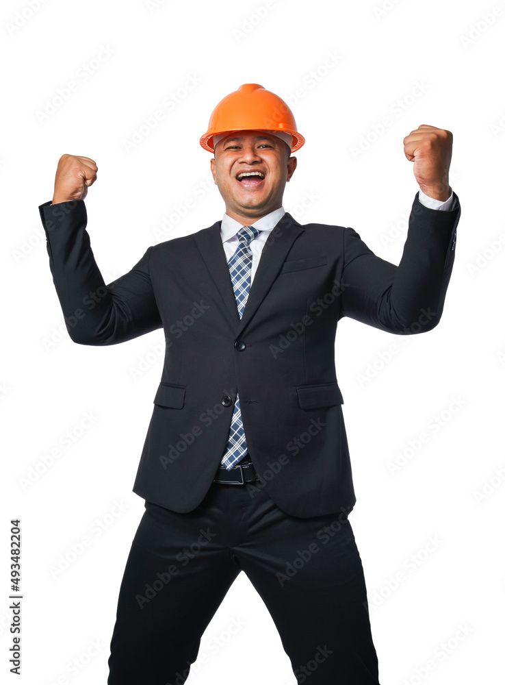 Portrait of a handsome chief engineer wearing a black suit and orange helmet clenching his fists in a very happy gesture isolated on white background, with clipping path.