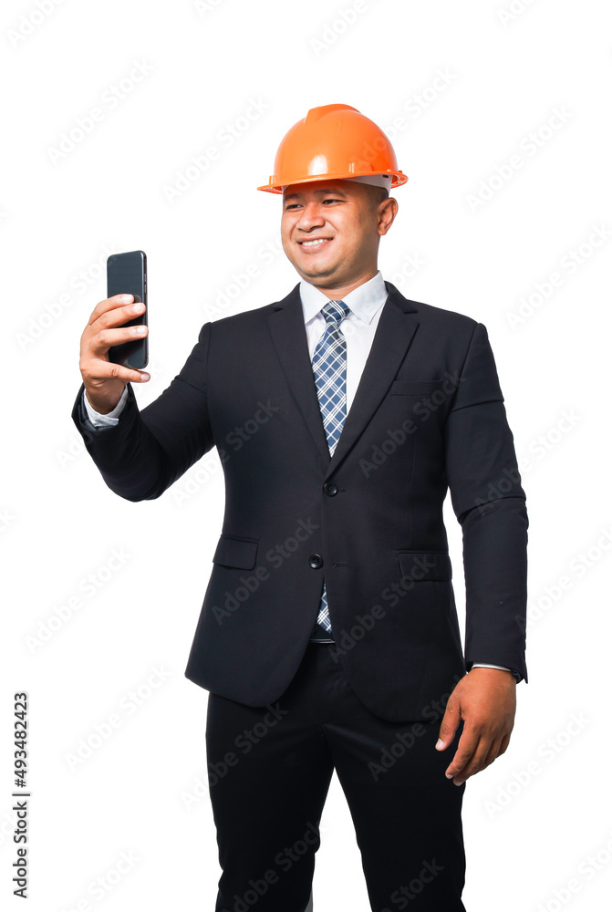 Portrait of a handsome chief engineer wearing a black suit and hard hat holding a phone. isolated on white background with clipping path Portrait of a handsome chief engineer wearing a black suit and hard hat holding a phone. isolated on white background with clipping path