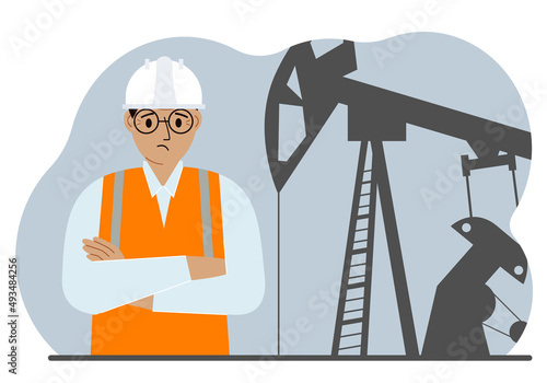 Oil refinery engineer. A male worker in front of a pumping unit for oil extraction, oil drilling and well repair.