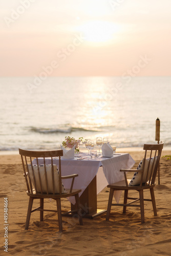 Dinner set for romantic couples on the beach with sunset.