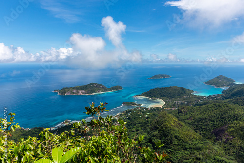 Landscape of Mahe Island, Seychelles, coastline from Morne Blanc View Point with lush tropical vegetation, crystal blue ocean and small tropical islands.