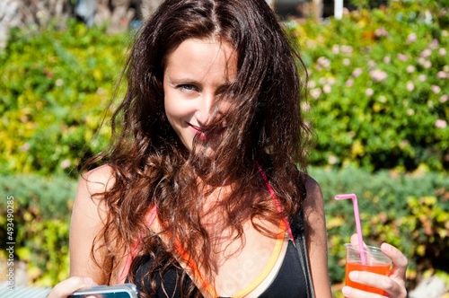 Dangerously sexy. happy young woman hold summer cocktail