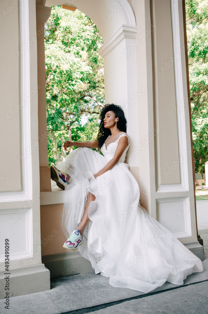 Beautiful portrait of a young and bright Afro-American girl in a wedding white dress Beautiful portrait of a young and bright Afro-American girl in a wedding white dress