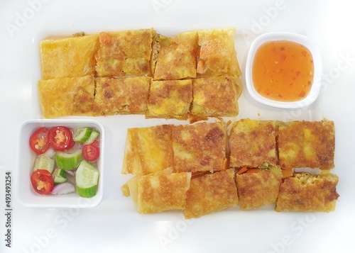 Murtabak, mutabbak, matabbak, or mutabbaq: a golden crispy stuffed pancake or pan-fried bread with the filling inside which composed of mix vegetable and beef, fish or chicken and curry. photo