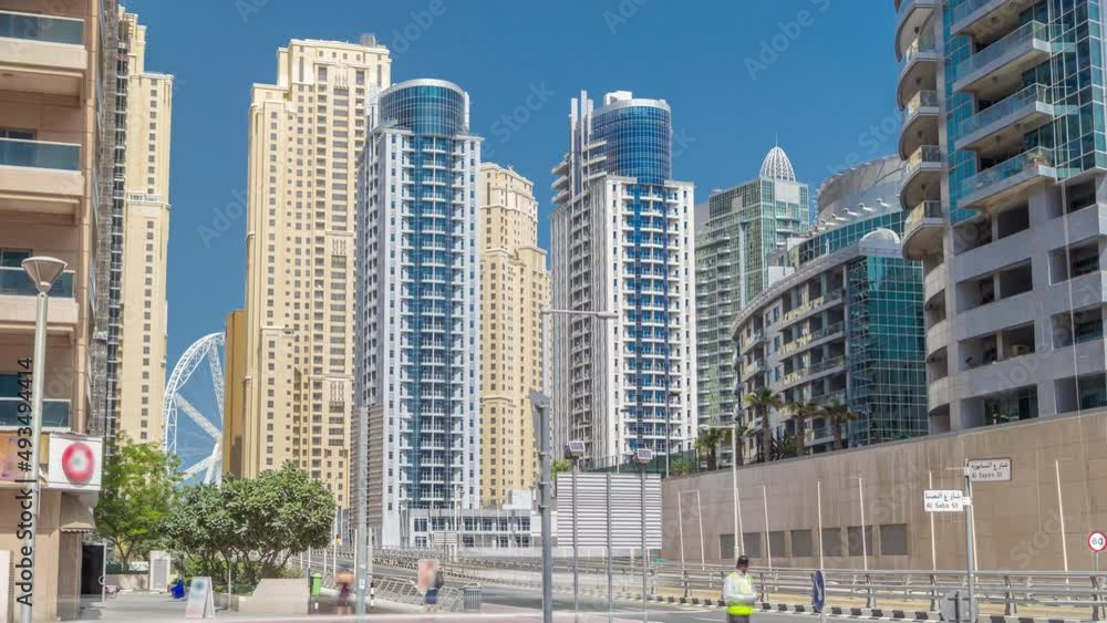 Dubai Marina with Skyscrapers timelapse and traffic on the street near concrete road bridge through the canal Dubai Marina with Skyscrapers timelapse and traffic on the street near concrete road bridge through the canal