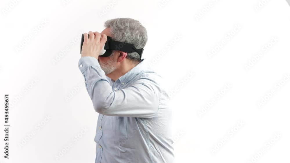 around 50 year old man looking around while having vr goggles on, white background. High quality 4k footage around 50 year old man looking around while having vr goggles on, white background. High quality 4k footage