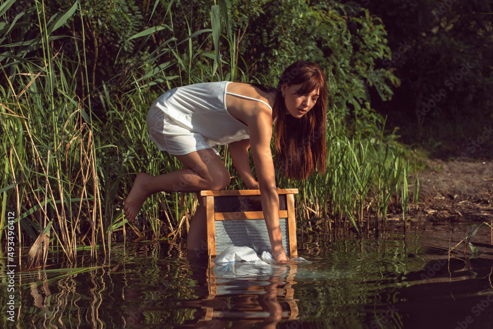 Fototapeta premium Young brunette woman on a sunny summer day
