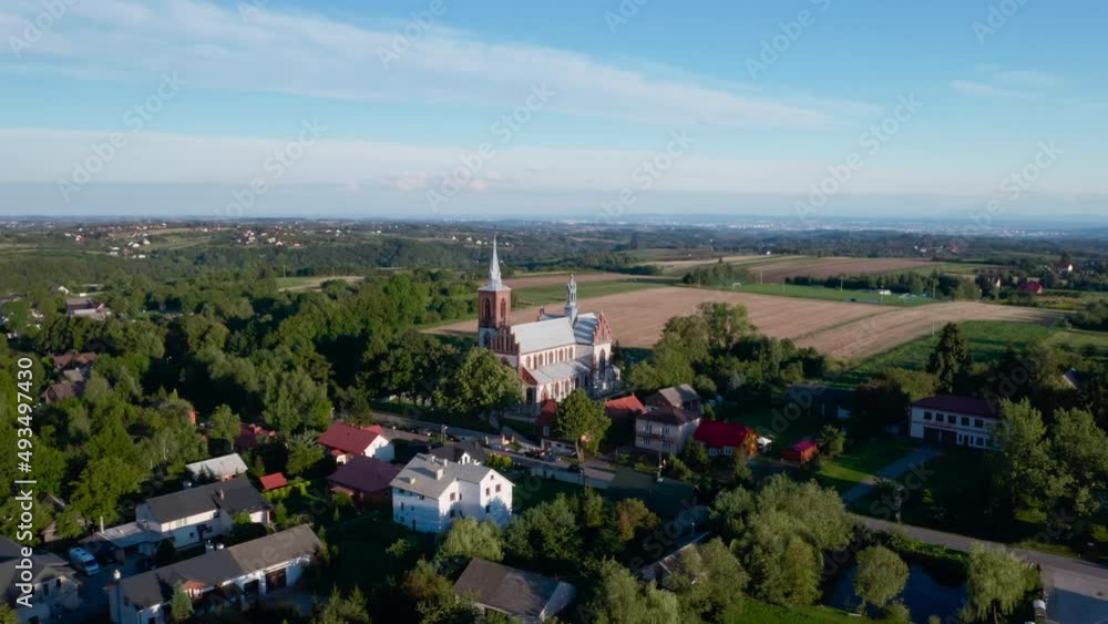 Smardzowice, drone aerial view of village and Gothic Revival church pw. Matki Bożej Różańcowej. 4k real time Orbit shot. Smardzowice, drone aerial view of village and Gothic Revival church pw. Matki Bożej Różańcowej. 4k real time Orbit shot.