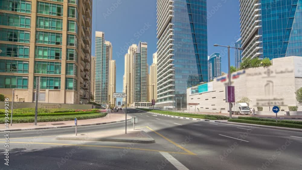 Dubai Marina with Skyscrapers timelapse hyperlapse and traffic on the street near concrete road bridge through the canal Dubai Marina with Skyscrapers timelapse hyperlapse and traffic on the street near concrete road bridge through the canal