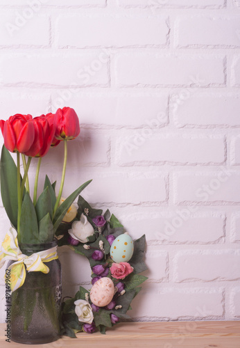 Fototapeta Naklejka Na Ścianę i Meble -  Easter home interior. Spring flowers in a vase and Easter eggs
