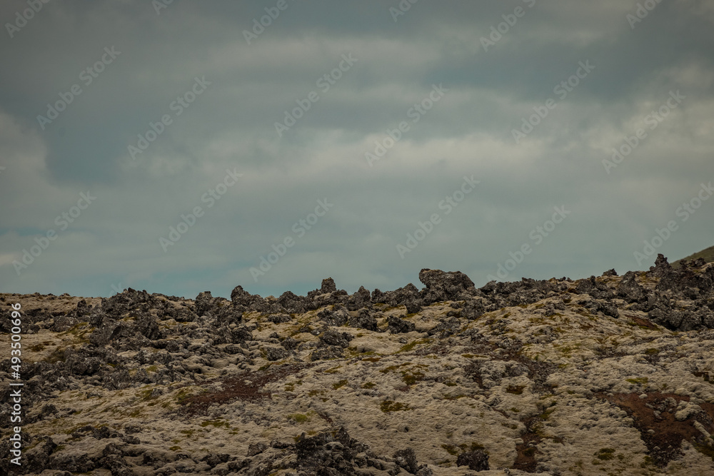 Obraz premium Famous Lava rock formations close to Snæfellsnesvegur, Iceland on a cloudy summer day. Magnificent lava fields opposed to grey skies.