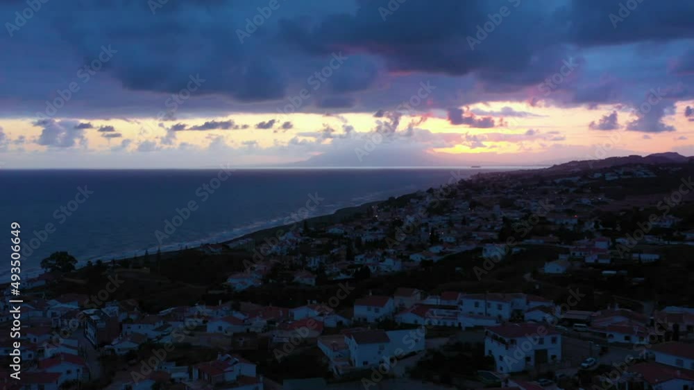 Fly over the village in the region of Malaga Andalusia Benajarafe Spain. Village of white houses on the shores of the Mediterranean Sea. Mediterranean landscape with beach and sunset. Malaga Spain Fly over the village in the region of Malaga Andalusia Benajarafe Spain. Village of white houses on the shores of the Mediterranean Sea. Mediterranean landscape with beach and sunset. Malaga Spain