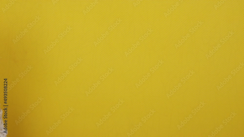 Hands holding a clapper board on a yellow isolated background Hands holding a clapper board on a yellow isolated background