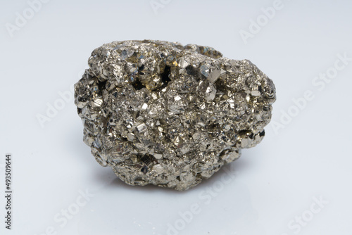 Raw crystalline pyrite (iron pyrite, fool's gold). Mineral pyrite from the group of sulfides. The mineral pyrite on a white background photo
