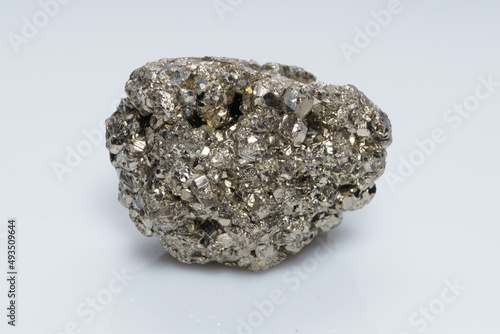 Raw crystalline pyrite (iron pyrite, fool's gold). Mineral pyrite from the group of sulfides. The mineral pyrite on a white background