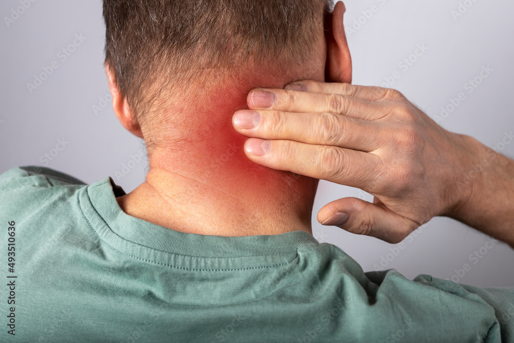 Fototapeta premium Man suffering from neck pain. Head back with red point closeup. Health problems and medicine concept. High quality photo