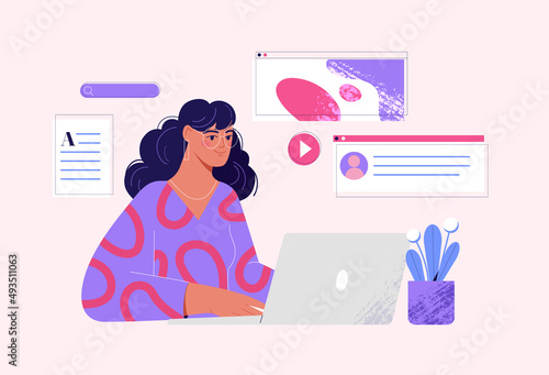 Woman working on laptop editing material, presentation, creating or writing content.