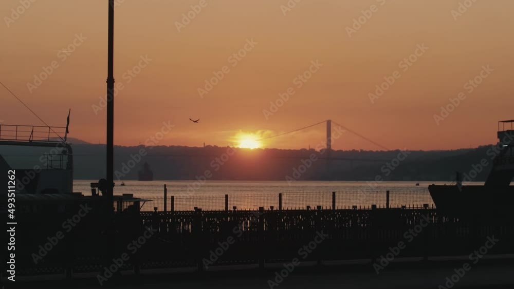 Peaceful background shot of orange sun setting over calm seaside pier scenery, magnificent ocean sunset panorama. Peaceful background shot of orange sun setting over calm seaside pier scenery, magnificent ocean sunset panorama.