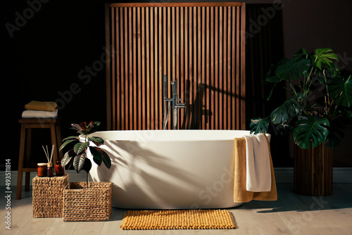 Cozy bathroom interior with stylish ceramic tub