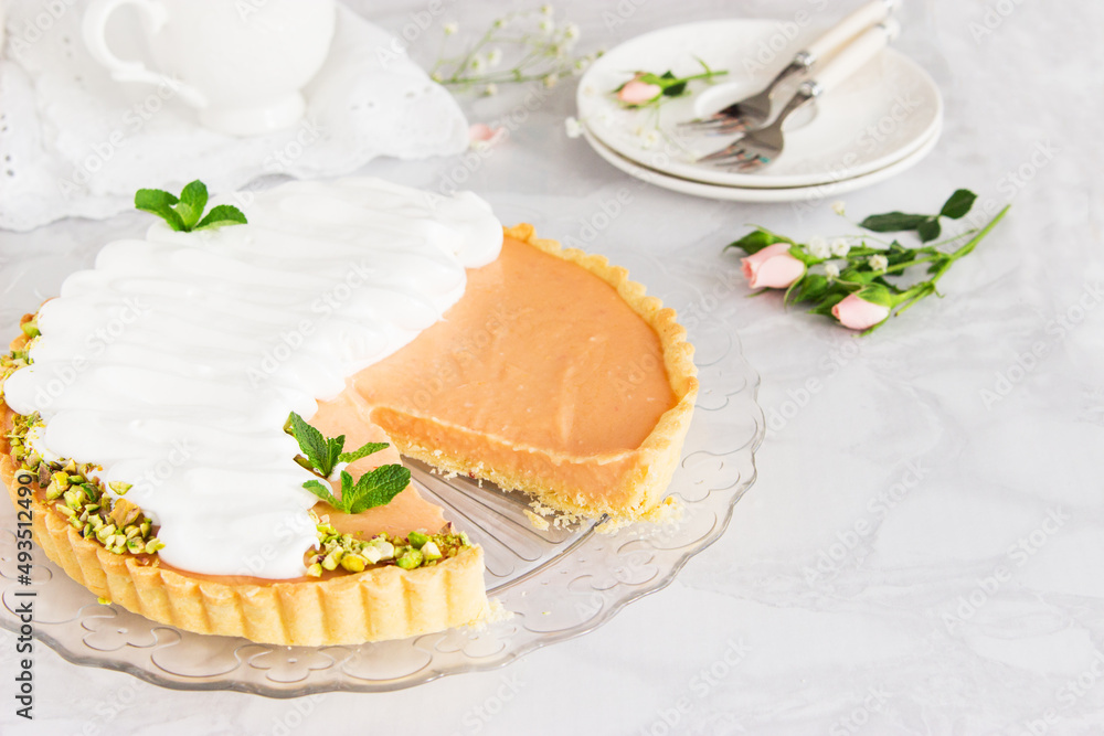 Grapefruit cream tart with pistachios and mint marble background. - obrazy, fototapety, plakaty 