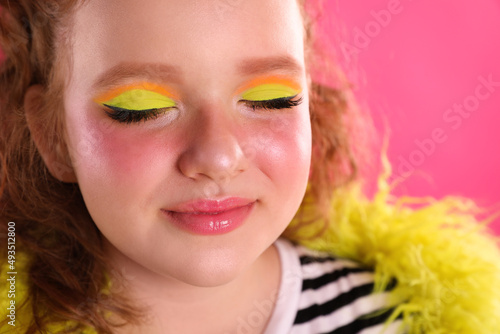 Cute indie girl with bright makeup on pink background  closeup