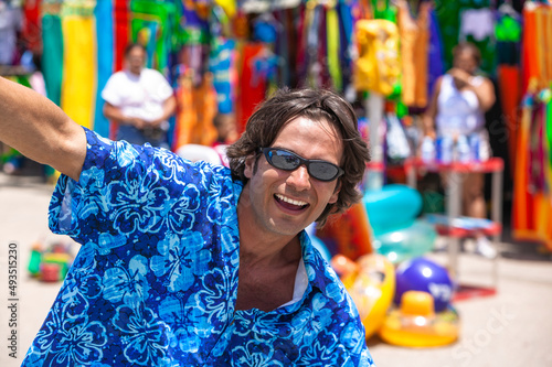 Man with sunglasses smiling in an outdoor market, Margarita Island, Venezuela © JUAN