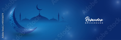 Islamic ramadan kareem banner background with crescent pattern moon star mosque lantern. Vector illustration. Ramadhan lantern blue colorful wide banner design background photo