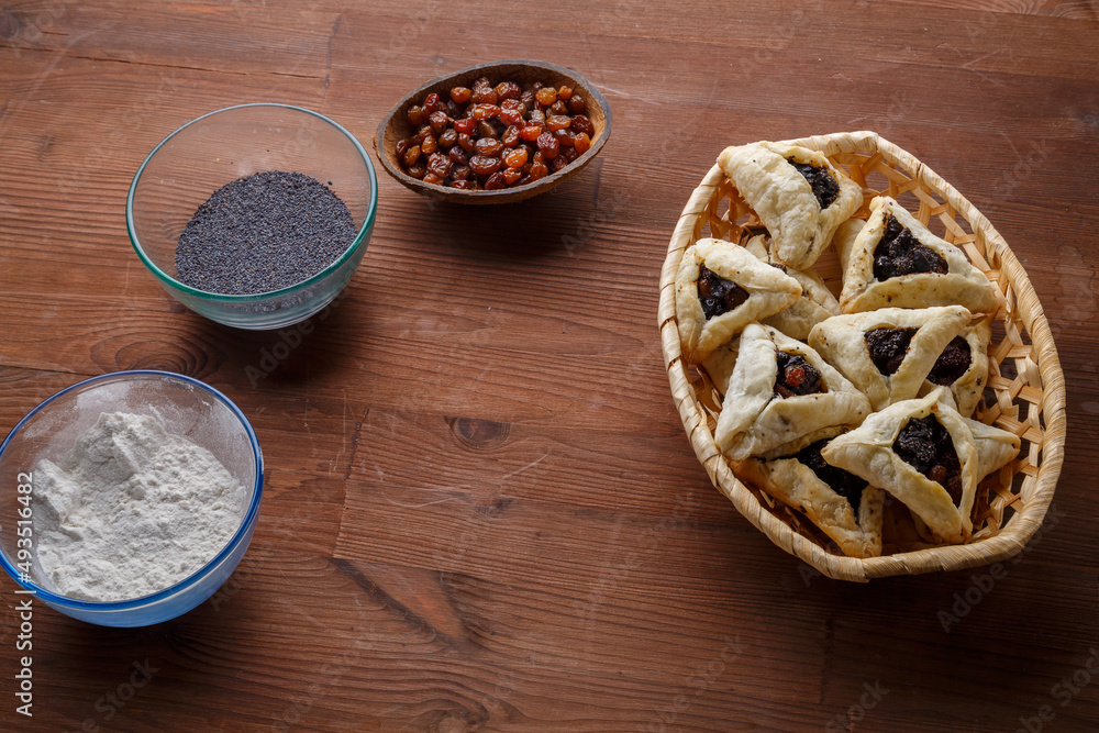 Freshly baked gomentash with poppy seeds and prunes for Purim.