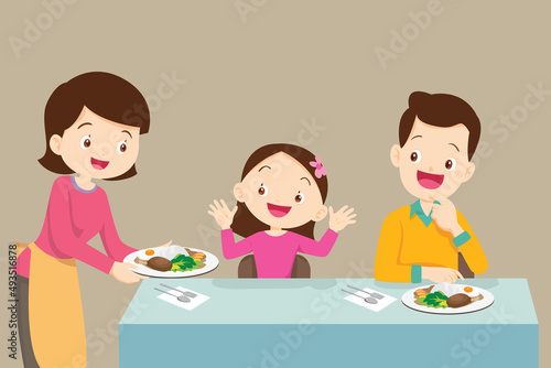 Mother serving food to family