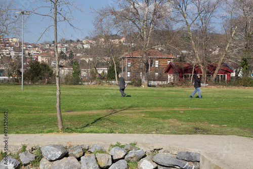 The two men walking in the park on a sunny day in pasabahce Istanbul, Turkey photo