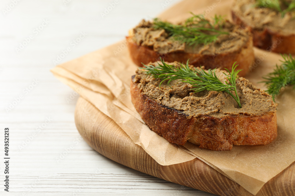 Slices of bread with delicious pate and dill on white wooden table, closeup. Space for text Slices of bread with delicious pate and dill on white wooden table, closeup. Space for text