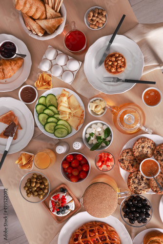 Fototapeta Naklejka Na Ścianę i Meble -  Dishes with different food on table, flat lay. Luxury brunch