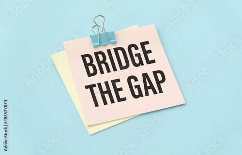 paper on the blue background with text Bridge The Gap