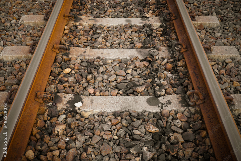 Naklejka premium Train tracks, railroad tracks on gravel type ballast or kricak.