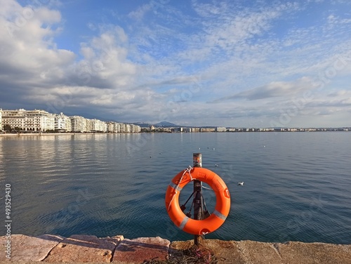  View of the seafront of Thessaloniki, Greece. Port and waterfront of Thessaloniki. Thermaikos Gulf. Lifebuoy on the pier