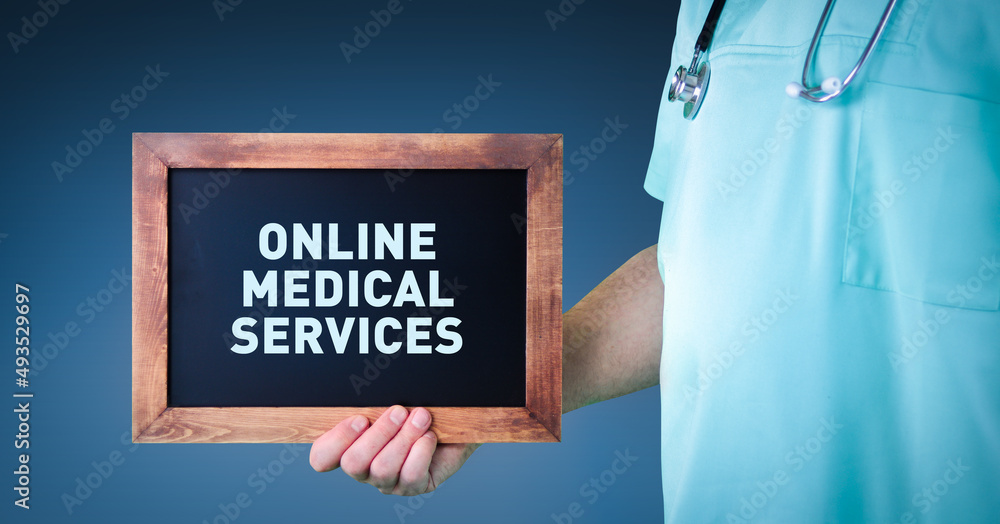 Online medical services. Doctor shows sign/board with wooden frame. Background blue Online medical services. Doctor shows sign/board with wooden frame. Background blue