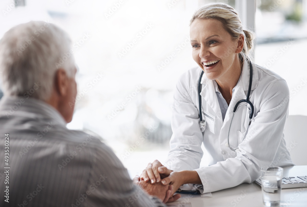 Fototapeta premium Im glad to see youre in such great health. Cropped shot of a mature female doctor working with a senior male patient in her office in the hospital.