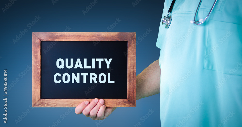 Medical Quality control. Doctor shows sign/board with wooden frame. Background blue Medical Quality control. Doctor shows sign/board with wooden frame. Background blue