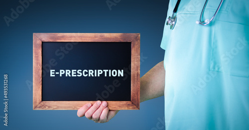 e-Prescription (Electronic prescribing). Doctor shows sign/board with wooden frame. Background blue photo