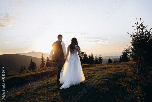 bride and groom walking in the field