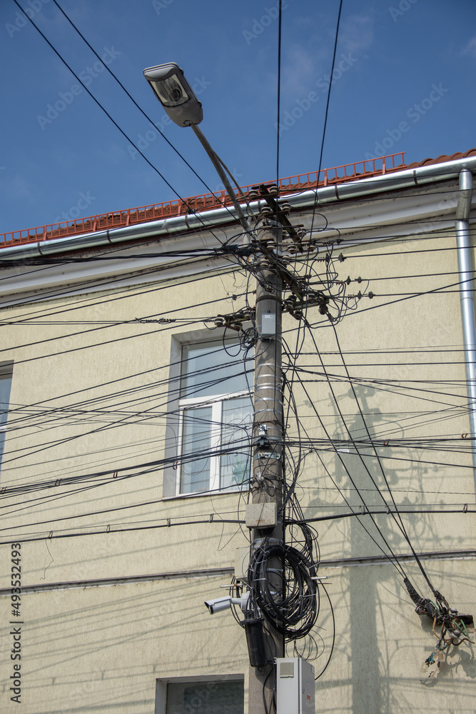 Electric cables telephone boxes and video cameras and on a pole, in Cluj, Romania, 2022 Electric cables telephone boxes and video cameras and on a pole, in Cluj, Romania, 2022