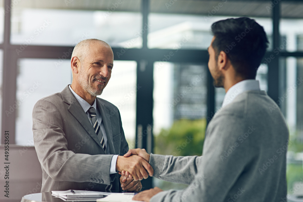 Glad to have you on board. Cropped shot of two businessmen shaking hands in an office. Glad to have you on board. Cropped shot of two businessmen shaking hands in an office.