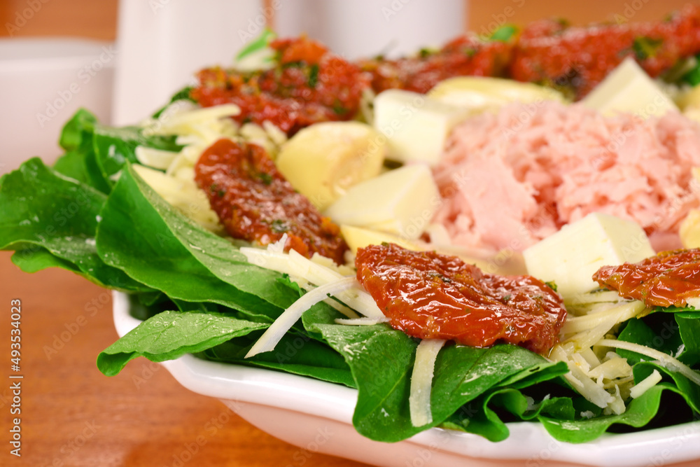 Dried tomatos and cold cuts salad close Dried tomatos and cold cuts salad close