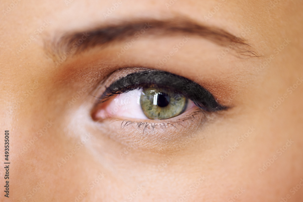 Beautifully made-up eye. Closeup of a vivid green eye with thick mascara-coated lashes. Beautifully made-up eye. Closeup of a vivid green eye with thick mascara-coated lashes.