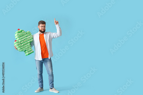 Smiling young man holding c...