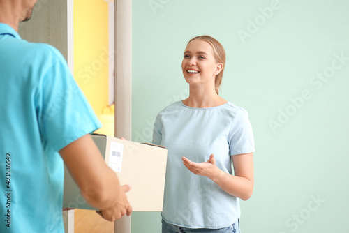 Young woman receiving parce...