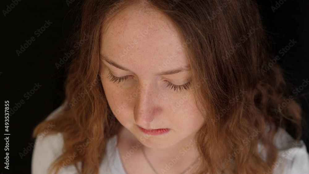 Young pensive girl with long red hair and white t-shirt Young pensive girl with long red hair and white t-shirt