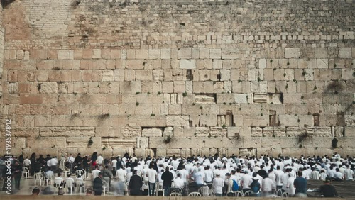 Crowd of Jewish people praying at the holy western wall in Old Jerusalem. Time lapse. 