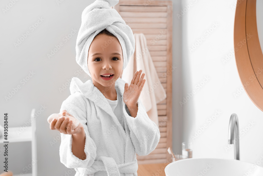 Cute little girl washing hands in bathroom Cute little girl washing hands in bathroom
