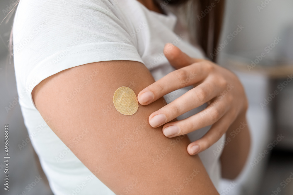 Photo & Art Print Young woman with applied nicotine patch at home